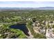 Wide aerial view showcasing the house's location near a picturesque lake and surrounding neighborhood at 6862 Independence Ct, Arvada, CO 80004