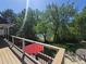 View from the back deck shows a lush green yard and mature trees offering shade and privacy at 6862 Independence Ct, Arvada, CO 80004