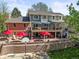Beautiful backyard featuring a spacious deck, a stone patio, and mature trees, perfect for outdoor living at 6862 Independence Ct, Arvada, CO 80004