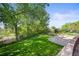 Lush green backyard with a basketball court and fence providing privacy and space for outdoor activities at 6862 Independence Ct, Arvada, CO 80004