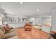 Finished basement offers built-in shelving, tile floors, and comfortable seating area at 6862 Independence Ct, Arvada, CO 80004