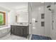 Modern bathroom with dual vanity, glass shower, and separate soaking tub at 6862 Independence Ct, Arvada, CO 80004