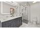 Bright bathroom with stylish vanity and a glass-enclosed shower at 6862 Independence Ct, Arvada, CO 80004