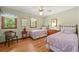 Charming bedroom with two twin beds, hardwood floors, and plenty of natural light at 6862 Independence Ct, Arvada, CO 80004