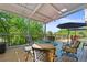Covered deck with comfortable seating, a fire pit, and scenic views, ideal for relaxing and entertaining at 6862 Independence Ct, Arvada, CO 80004