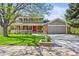Charming two-story home with a landscaped front yard, covered porch, and inviting red front door at 6862 Independence Ct, Arvada, CO 80004