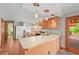 Well-lit kitchen featuring wood cabinets and an eat-in counter at 6862 Independence Ct, Arvada, CO 80004