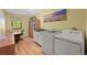 Efficient laundry room area with washer, dryer, and a work area at 6862 Independence Ct, Arvada, CO 80004