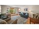 Inviting living room with large windows, comfortable seating, and a grand piano at 6862 Independence Ct, Arvada, CO 80004