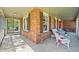 Charming front porch with brick accents and cozy seating area at 6862 Independence Ct, Arvada, CO 80004