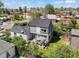 Aerial view of a home's backyard featuring a patio with furniture and a well-manicured lawn at 1354 Tamarac St, Denver, CO 80220