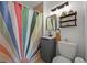 Stylish bathroom with a unique shower curtain, modern vanity, and well-placed lighting at 1354 Tamarac St, Denver, CO 80220