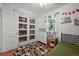 Comfortable bedroom with wood floors, neutral walls, and a charming window at 1354 Tamarac St, Denver, CO 80220