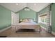 Bright bedroom with vaulted ceiling, light green walls, and comfortable bed at 1354 Tamarac St, Denver, CO 80220
