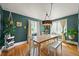 Well-lit dining room featuring hardwood floors, stylish chandelier, and bright windows at 1354 Tamarac St, Denver, CO 80220
