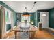 Large dining room with hardwood floors, stylish light fixture, and a view of the front yard at 1354 Tamarac St, Denver, CO 80220