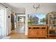 Open-concept living room boasting a wood-burning fireplace and hardwood floors flowing into the kitchen at 1354 Tamarac St, Denver, CO 80220