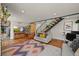 Open living space with hardwood floors, fireplace, and staircase in a cozy and inviting setting at 1354 Tamarac St, Denver, CO 80220