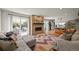 Cozy living room with a brick fireplace and a sliding glass door to the patio at 1354 Tamarac St, Denver, CO 80220