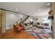 Spacious living room featuring hardwood floors, comfortable seating, and a staircase at 1354 Tamarac St, Denver, CO 80220