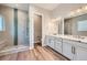 Bathroom featuring a glass shower and double sinks at 400 Basin Daisy St, Castle Rock, CO 80104