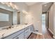 Bathroom featuring double sinks, granite countertops, and wood-look flooring at 400 Basin Daisy St, Castle Rock, CO 80104