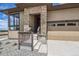 Inviting entryway featuring stone accents, a covered porch, and direct access to the garage at 400 Basin Daisy St, Castle Rock, CO 80104