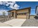Beautifully landscaped single-Gathering home showcasing stone accents and a two-car garage at 400 Basin Daisy St, Castle Rock, CO 80104