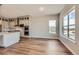 Spacious kitchen and breakfast area with wood floors and large windows at 400 Basin Daisy St, Castle Rock, CO 80104