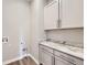 Laundry room showcasing granite countertops, modern cabinetry, and hookups for washer and dryer at 400 Basin Daisy St, Castle Rock, CO 80104