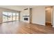 Bright and airy living room with a modern fireplace, wood flooring, and sliding glass doors at 400 Basin Daisy St, Castle Rock, CO 80104