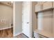 Mudroom features bench seating, coat hooks, storage cabinets, and easy access to laundry hookups at 400 Basin Daisy St, Castle Rock, CO 80104