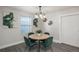 Bright dining area with a round table and four green velvet chairs at 12048 E Canal Dr, Aurora, CO 80011