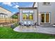 Cozy outdoor patio seating area, great for entertaining with plush seating and green foliage all around at 7114 S Acoma Way, Littleton, CO 80120