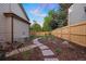 Fenced backyard with stepping stone pathway and landscape features at 7114 S Acoma Way, Littleton, CO 80120
