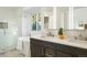 Spa-like bathroom featuring a freestanding tub, glass-enclosed shower, dual sink vanity, and stylish tile flooring at 7114 S Acoma Way, Littleton, CO 80120