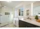 Spa-like bathroom with a soaking tub, glass-enclosed shower, and sleek vanity for ultimate relaxation at 7114 S Acoma Way, Littleton, CO 80120