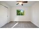 Bright bedroom with carpeted floor, closet, and large window offering view of greenery, creating a serene atmosphere at 7114 S Acoma Way, Littleton, CO 80120