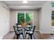 Cozy dining area with modern black chairs, a round table, and sliding glass doors to the backyard at 7114 S Acoma Way, Littleton, CO 80120