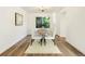 Elegant dining room with a rustic table, seating for six, and a charming chandelier, perfect for gatherings at 7114 S Acoma Way, Littleton, CO 80120
