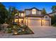 Charming two-story home with manicured landscaping, exterior lighting, and a three-car garage at 7114 S Acoma Way, Littleton, CO 80120