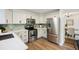 Modern kitchen with stainless steel appliances, white countertops, and sleek cabinetry at 7114 S Acoma Way, Littleton, CO 80120