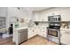 Well appointed kitchen with stainless appliances and ample countertop space open to the living room at 7114 S Acoma Way, Littleton, CO 80120