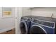 Modern laundry room with a new, front-loading washer and dryer at 7114 S Acoma Way, Littleton, CO 80120