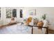 Cozy living room features a large window and neutral decor, creating a relaxing and inviting atmosphere at 7114 S Acoma Way, Littleton, CO 80120