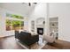 Bright living room with fireplace, built-in shelving, and large windows offering ample natural light at 7114 S Acoma Way, Littleton, CO 80120