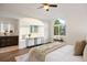 Bright main bedroom with a large arched window, a console table, and modern furnishings at 7114 S Acoma Way, Littleton, CO 80120