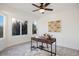 Bright home office with a large window, modern desk, stylish decor, and ceiling fan at 7114 S Acoma Way, Littleton, CO 80120