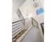 Stylish staircase featuring modern black metal railings, carpeted steps, and unique lighting fixtures at 7114 S Acoma Way, Littleton, CO 80120