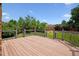 Spacious wooden deck with railing overlooking a lush backyard at 8174 Dudley Cir, Arvada, CO 80005